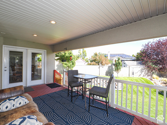 11779 South Stone Ridge Court Ridge West Riverton, UT 84065 - Photo 76 of 85 Covered porch featuring white double-pane French doors, a red wood-finish deck, white railing, and recessed lighting