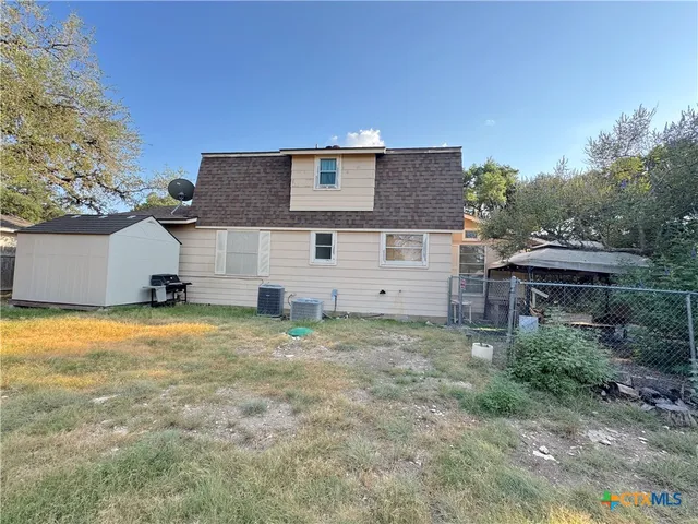 a view of a house with a backyard