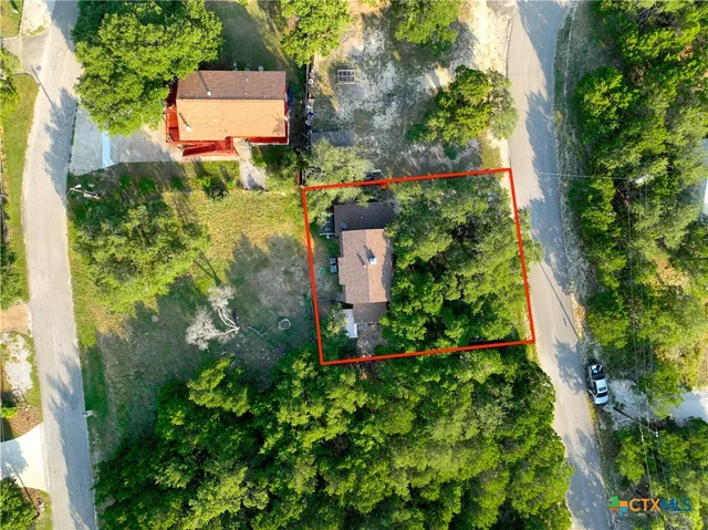 an aerial view of a house with a yard