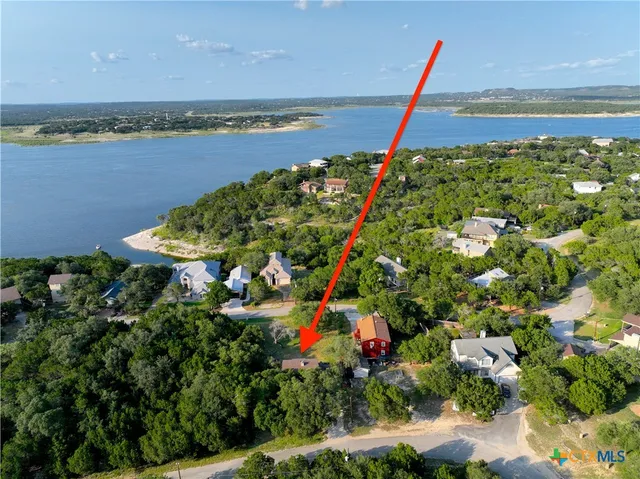 a view of a terrace with a lake and trees in the background