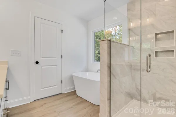 a bathroom with a bathtub and shower