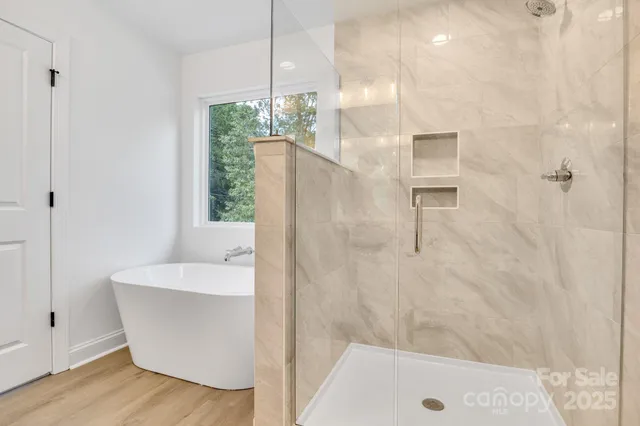 a bathroom with a bathtub and shower