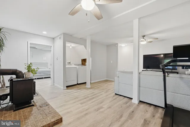a view of a kitchen with furniture and wooden floor