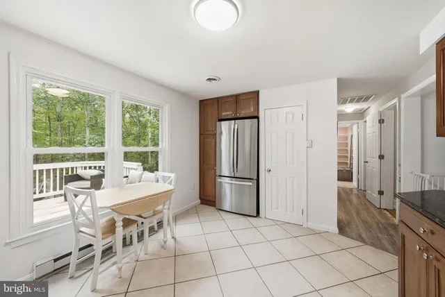 a kitchen with stainless steel appliances granite countertop a stove top oven a refrigerator and a microwave oven