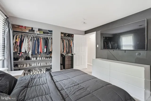 a bedroom with a bed and a large mirror