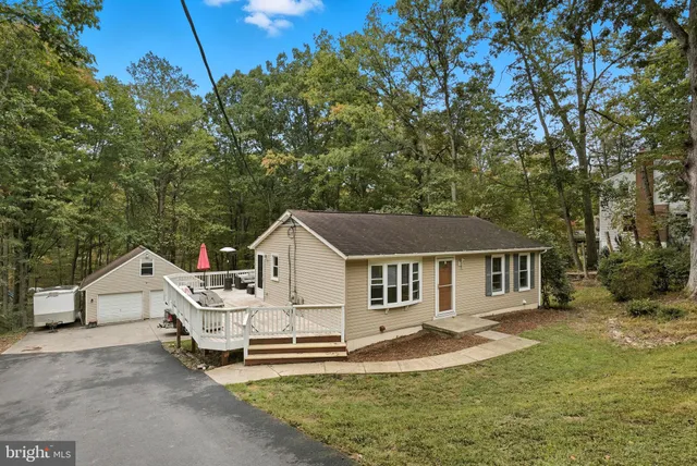 a view of a house with a yard and sitting area