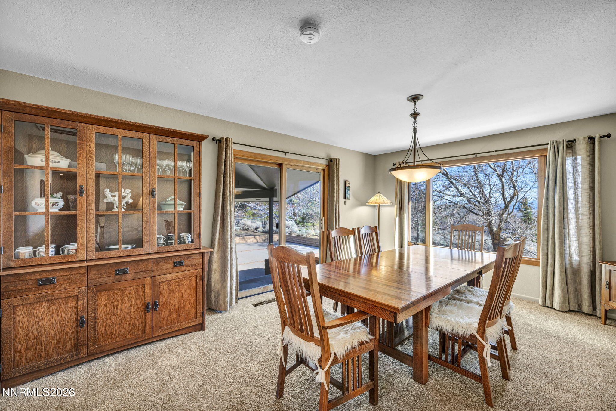 3464 Alpine View Court Carson City, NV 89705 - Photo 20 of 97 a dining room with furniture large windows and a chandelier