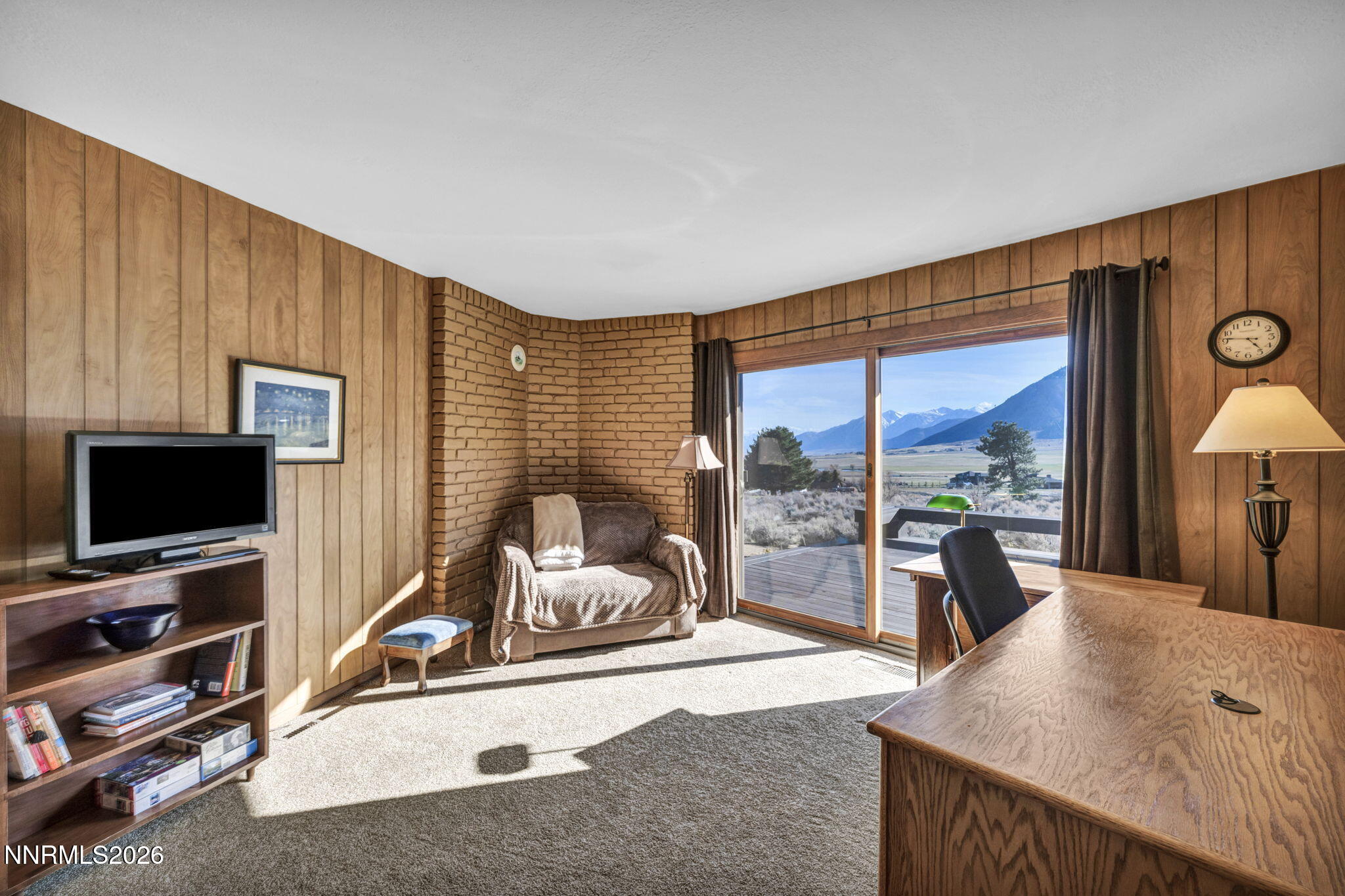 3464 Alpine View Court Carson City, NV 89705 - Photo 30 of 97 a living room with furniture a flat screen tv and a floor to ceiling window