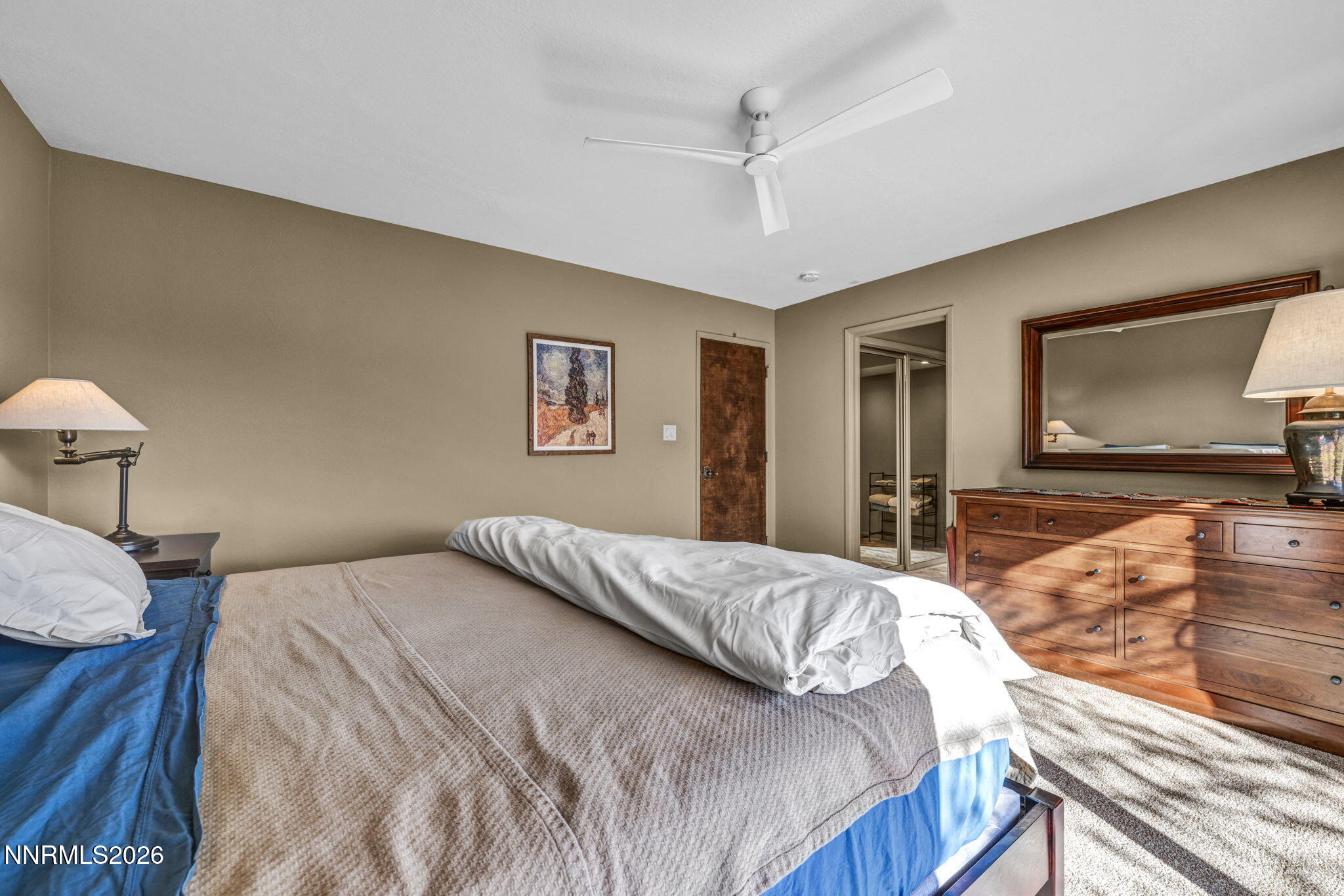 3464 Alpine View Court Carson City, NV 89705 - Photo 34 of 97 a bedroom with a large bed a flat tv screen and dresser