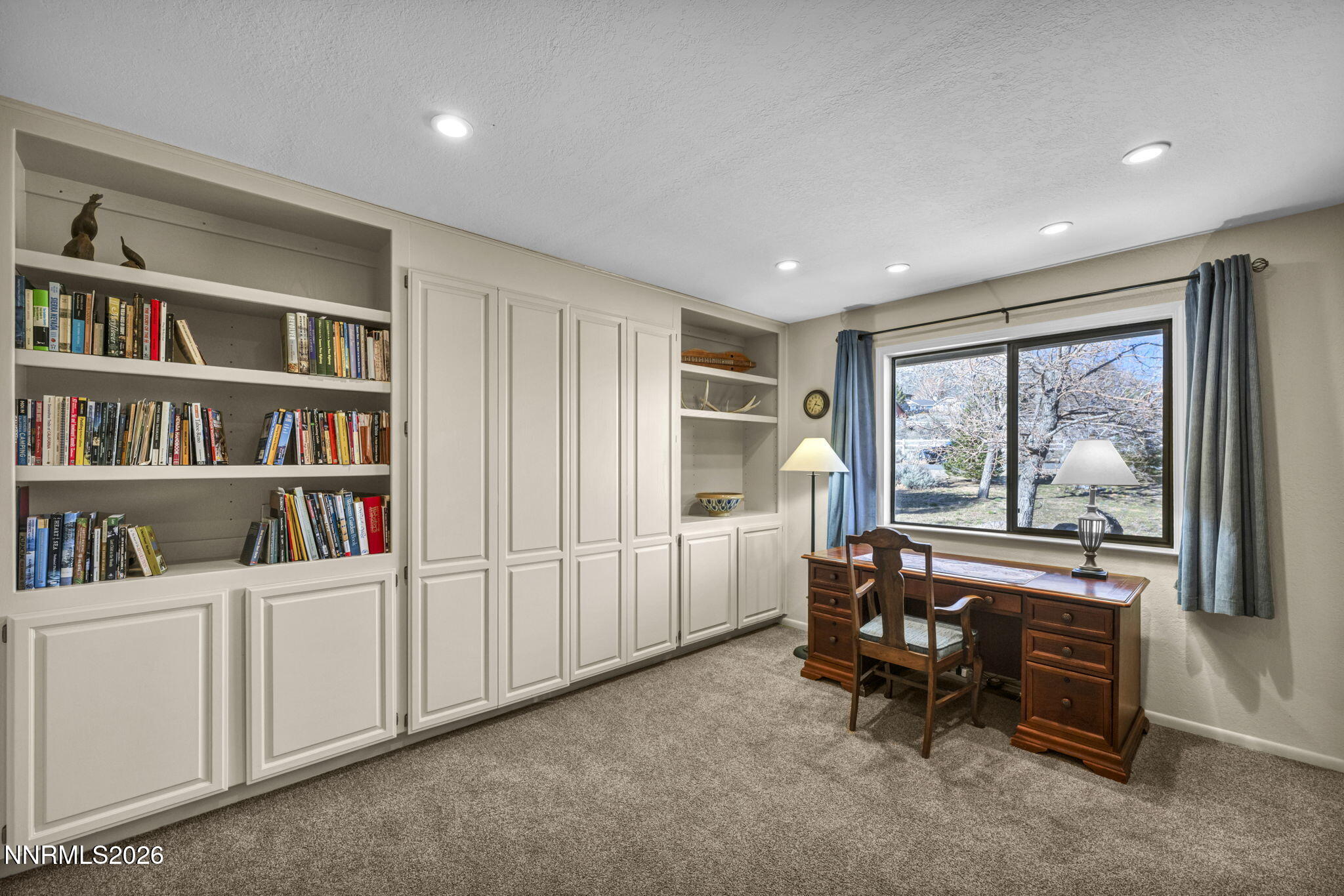 3464 Alpine View Court Carson City, NV 89705 - Photo 42 of 97 a living room with furniture and a book shelf