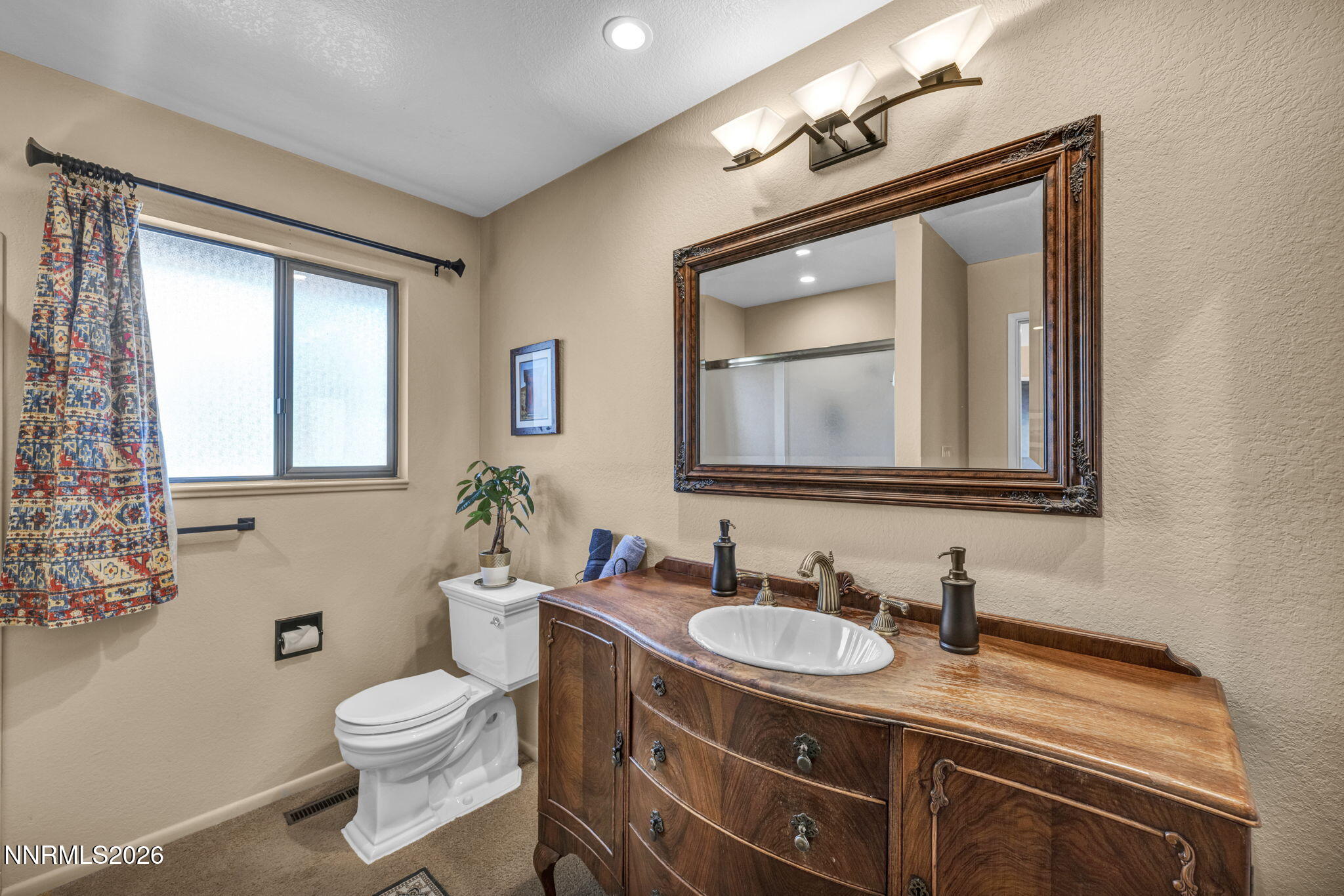 3464 Alpine View Court Carson City, NV 89705 - Photo 45 of 97 a bathroom with a granite countertop sink vanity mirror and toilet