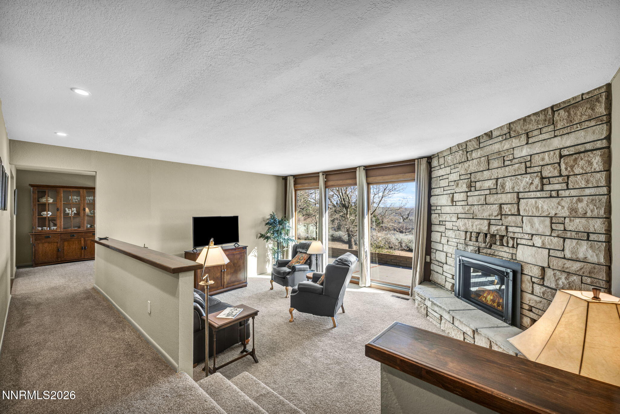 3464 Alpine View Court Carson City, NV 89705 - Photo 8 of 97 a living room with furniture a fireplace and a flat screen tv