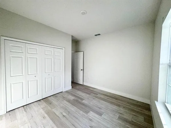 a view of an empty room and wooden floor
