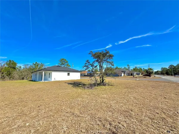 a house view with a backyard space