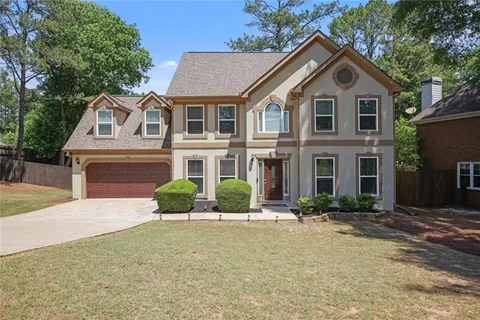 a front view of a house with a yard
