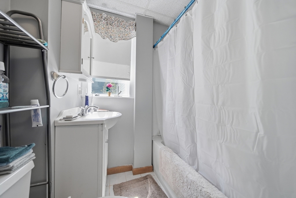 436 Franklin Road Fitchburg, MA 01420 - Photo 12 of 41 a bathroom with a sink a mirror and shower