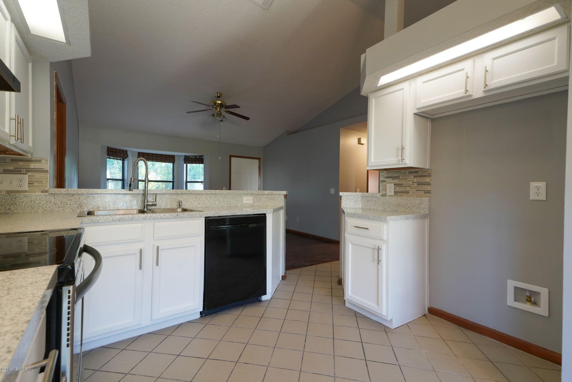 2148 Rothbury Drive Jacksonville, FL 32221 - Photo 11 of 36 a kitchen with a stove a sink and a refrigerator
