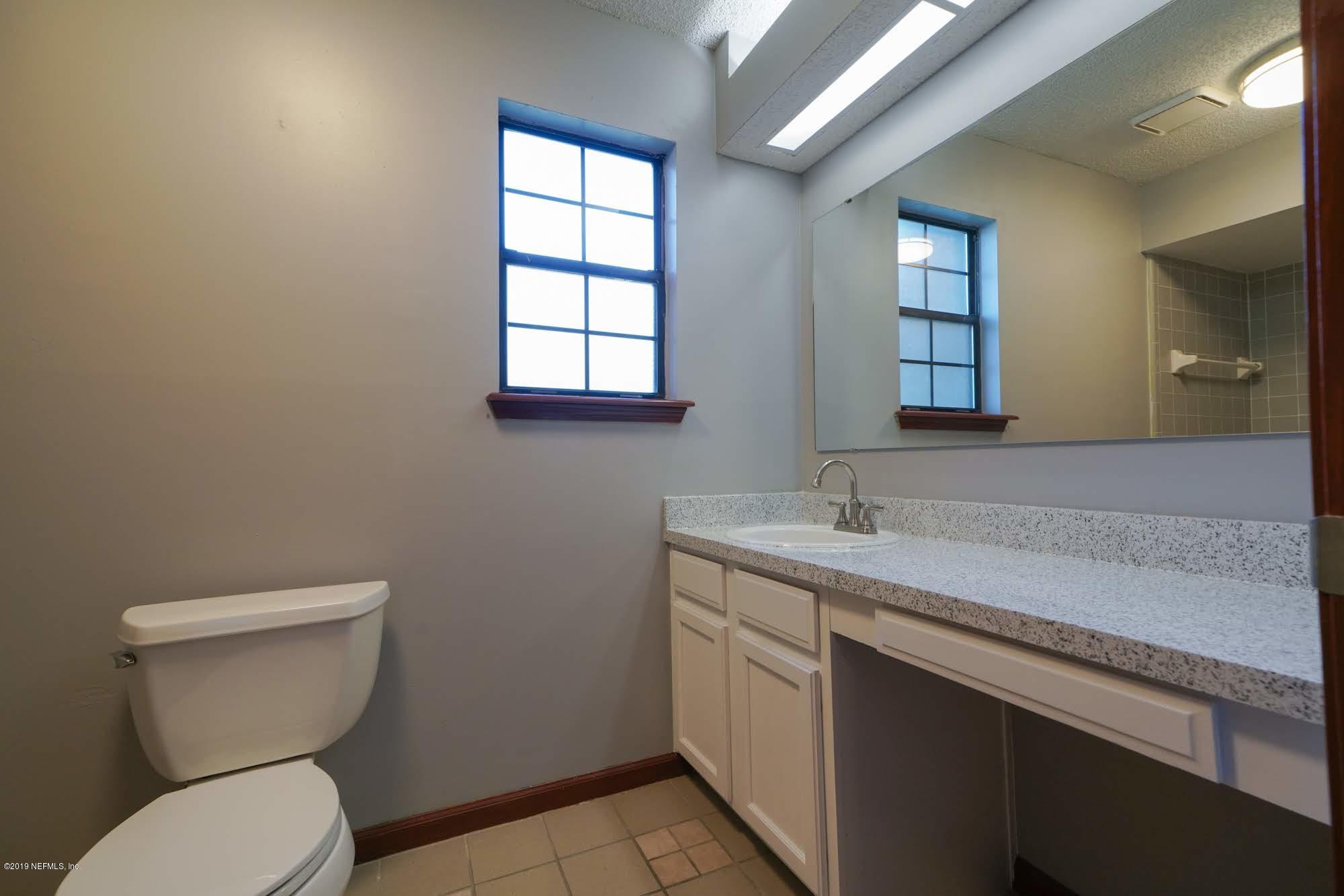 2148 Rothbury Drive Jacksonville, FL 32221 - Photo 17 of 36 a bathroom with a toilet sink and mirror