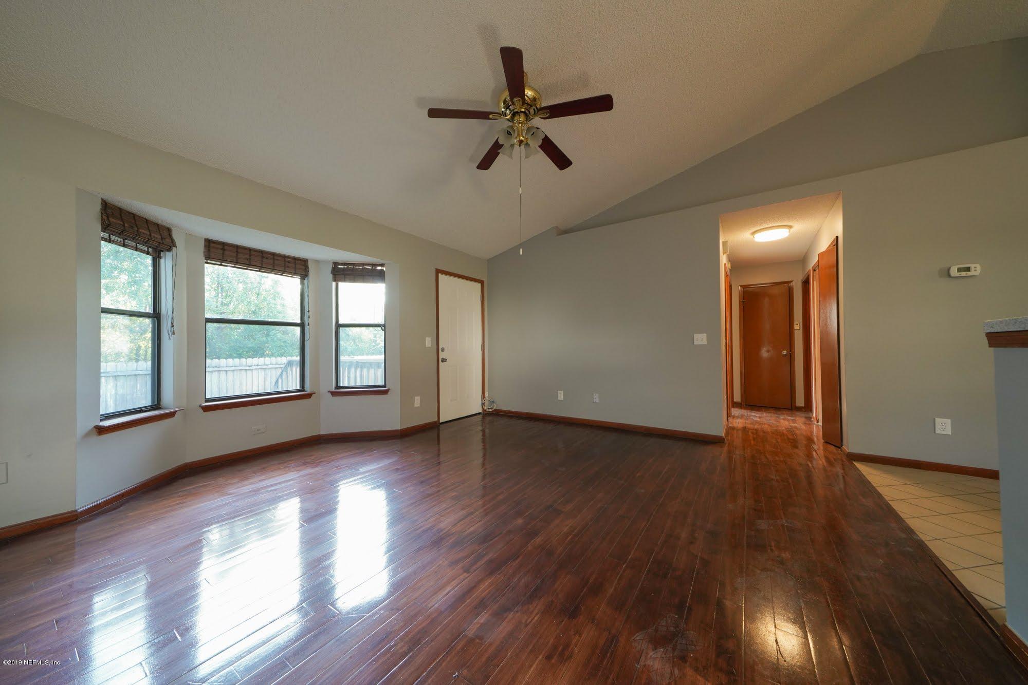 2148 Rothbury Drive Jacksonville, FL 32221 - Photo 19 of 36 a view of empty room with wooden floor and fan