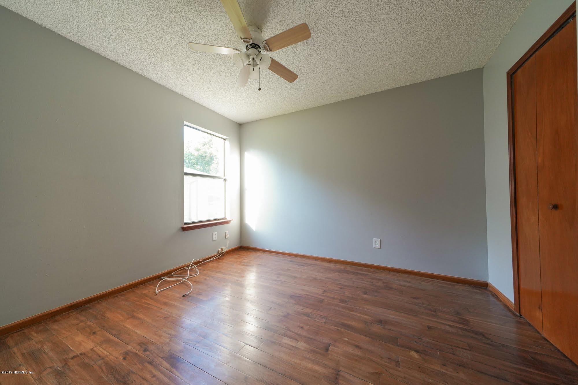2148 Rothbury Drive Jacksonville, FL 32221 - Photo 22 of 36 wooden floor in an empty room with a window
