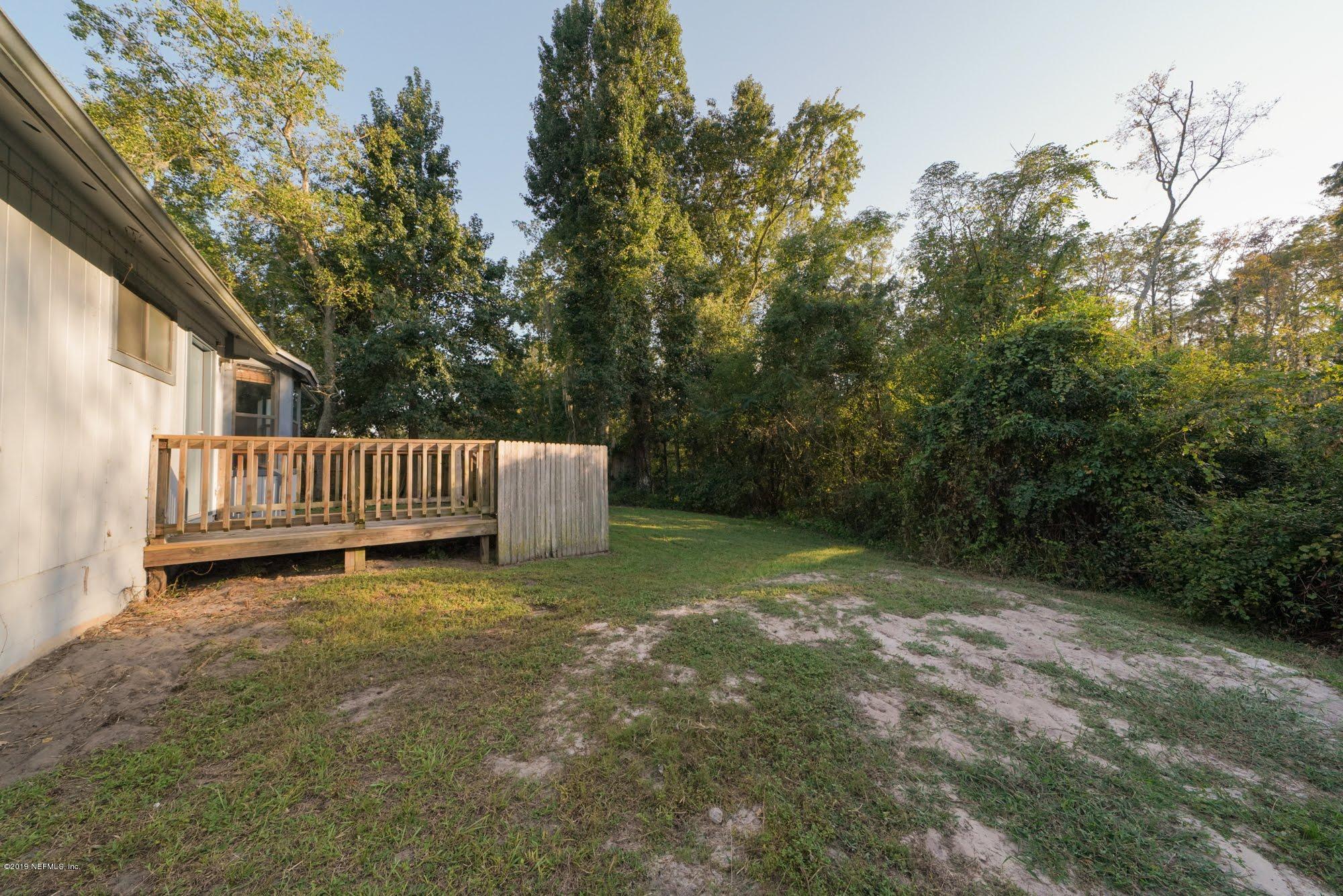 2148 Rothbury Drive Jacksonville, FL 32221 - Photo 27 of 36 a view of backyard with wooden fence and trees