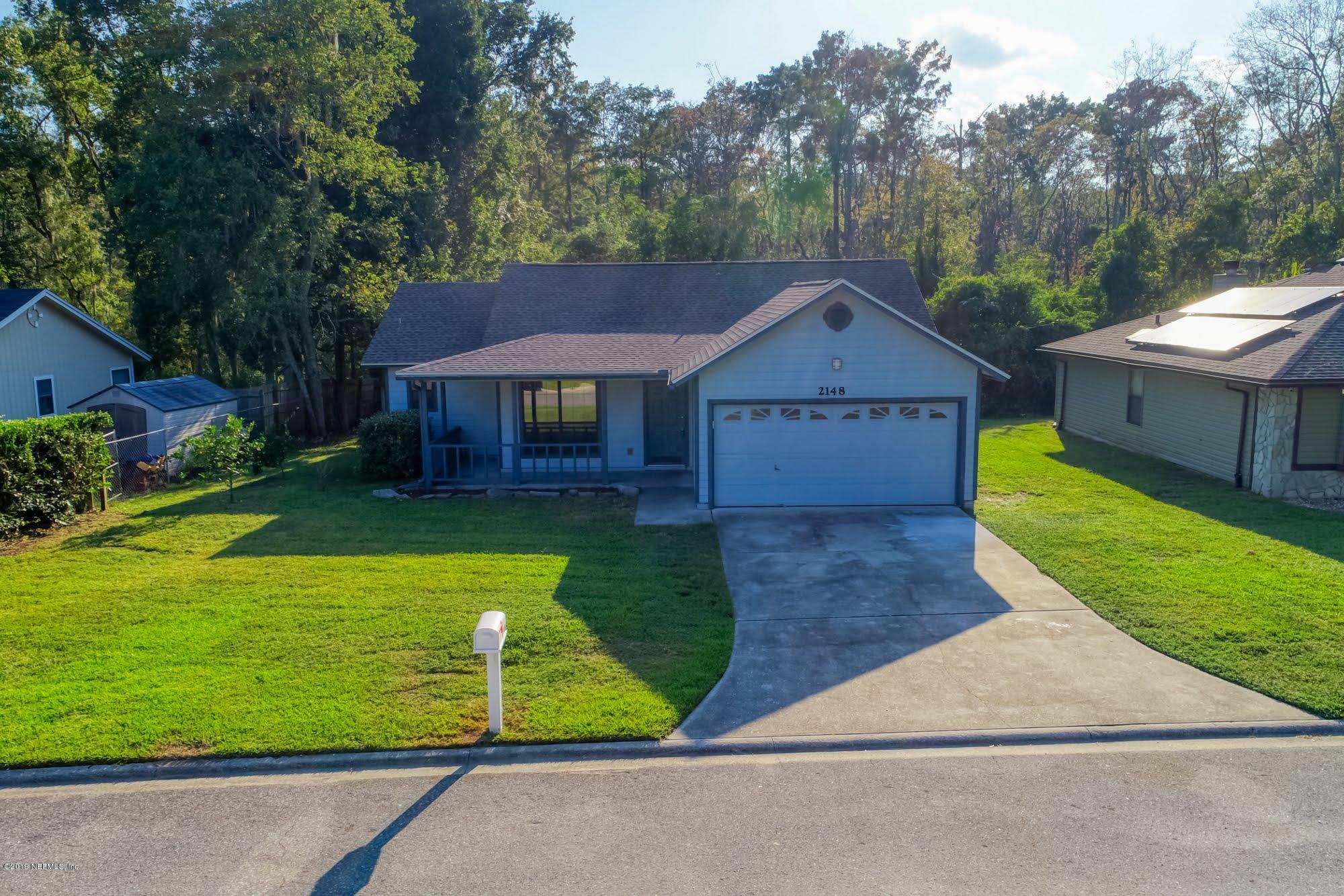 2148 Rothbury Drive Jacksonville, FL 32221 - Photo 30 of 36 a front view of a house with a yard and trees