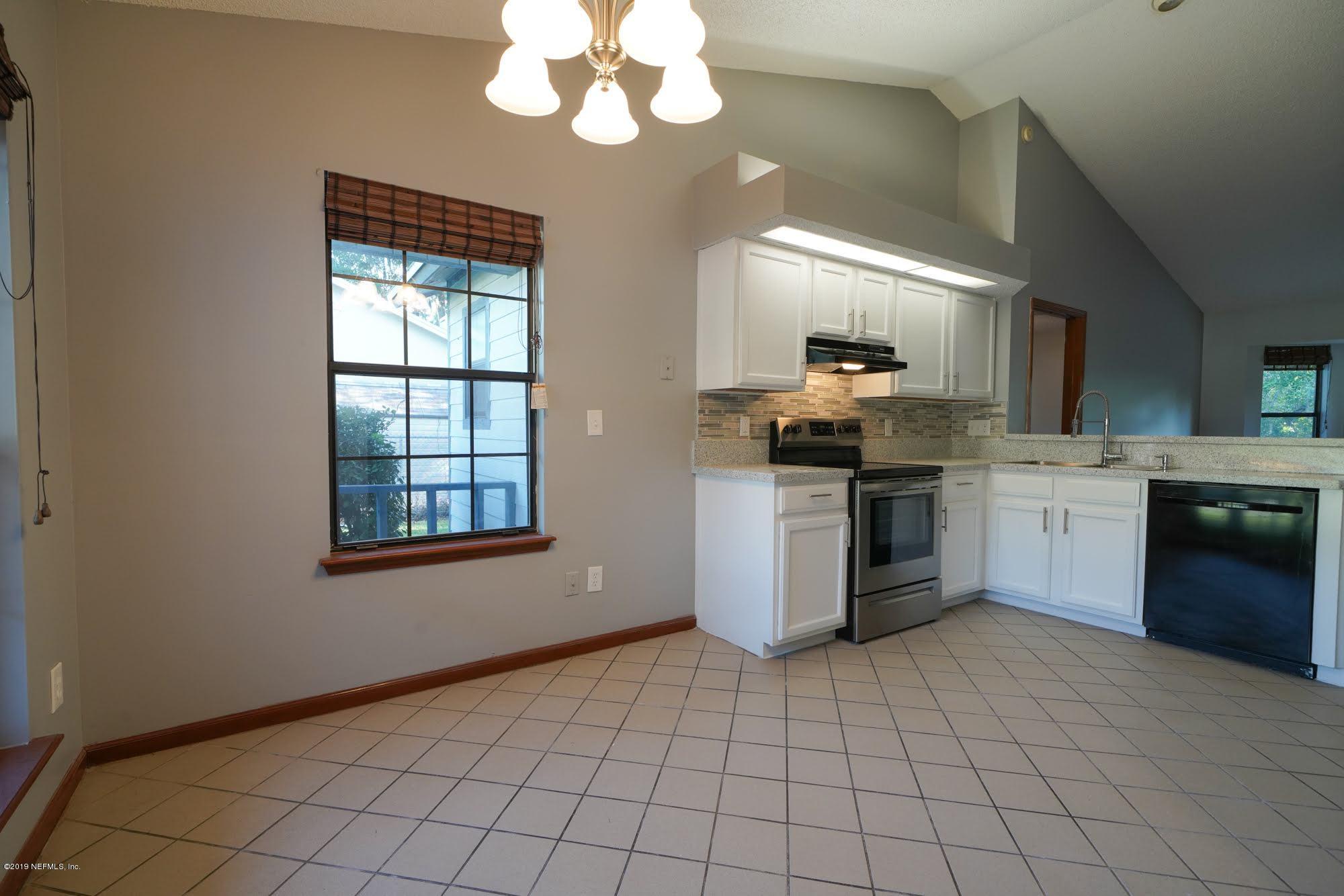2148 Rothbury Drive Jacksonville, FL 32221 - Photo 7 of 36 a kitchen with stainless steel appliances granite countertop a stove sink and cabinets