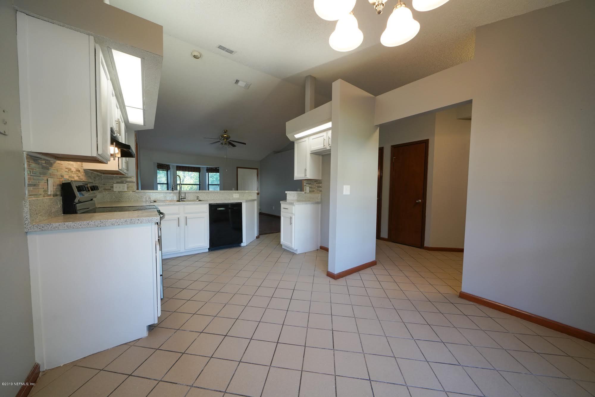 2148 Rothbury Drive Jacksonville, FL 32221 - Photo 8 of 36 a kitchen with stainless steel appliances granite countertop a refrigerator and a sink