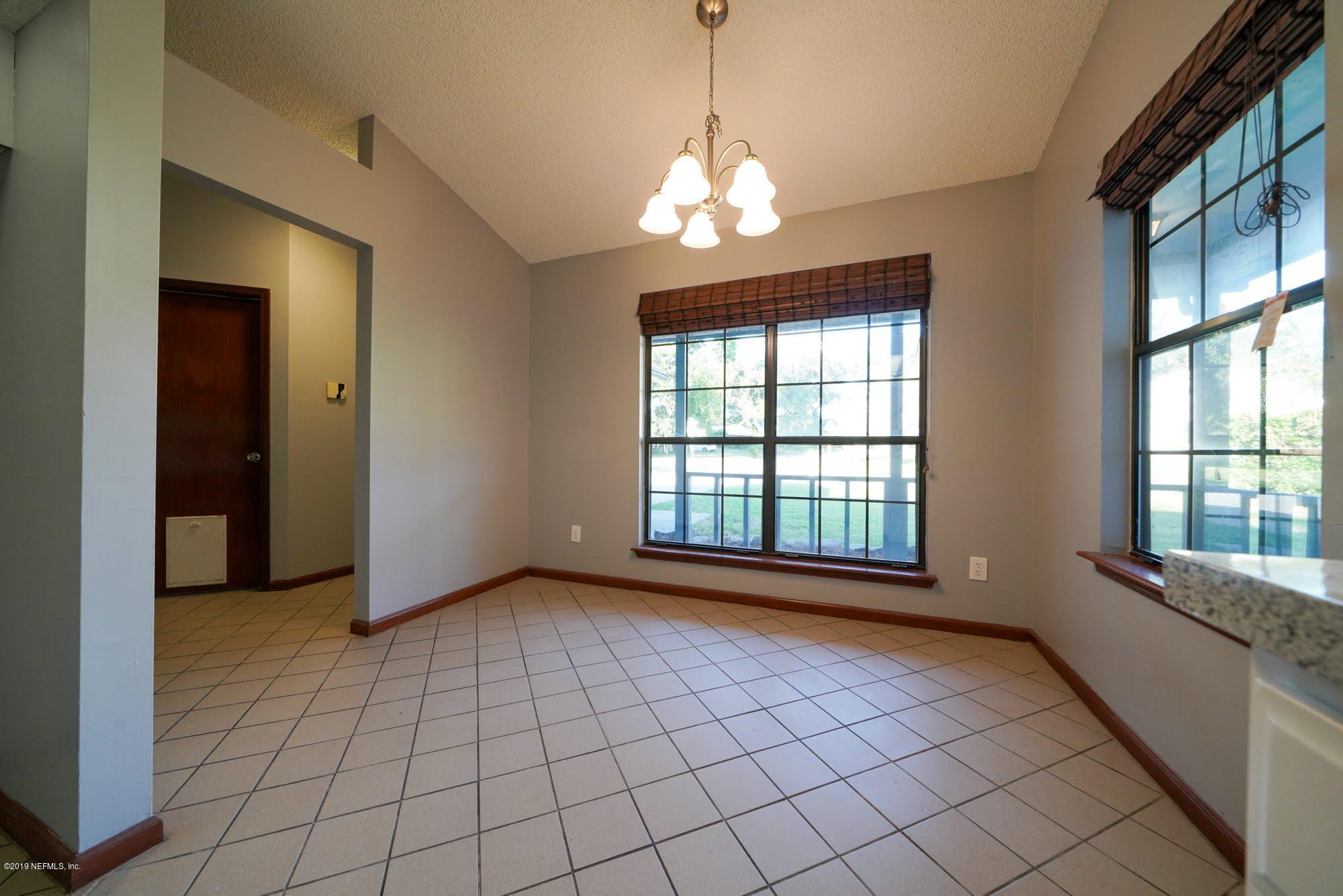 2148 Rothbury Drive Jacksonville, FL 32221 - Photo 9 of 36 a view of an empty room with a window and chandelier
