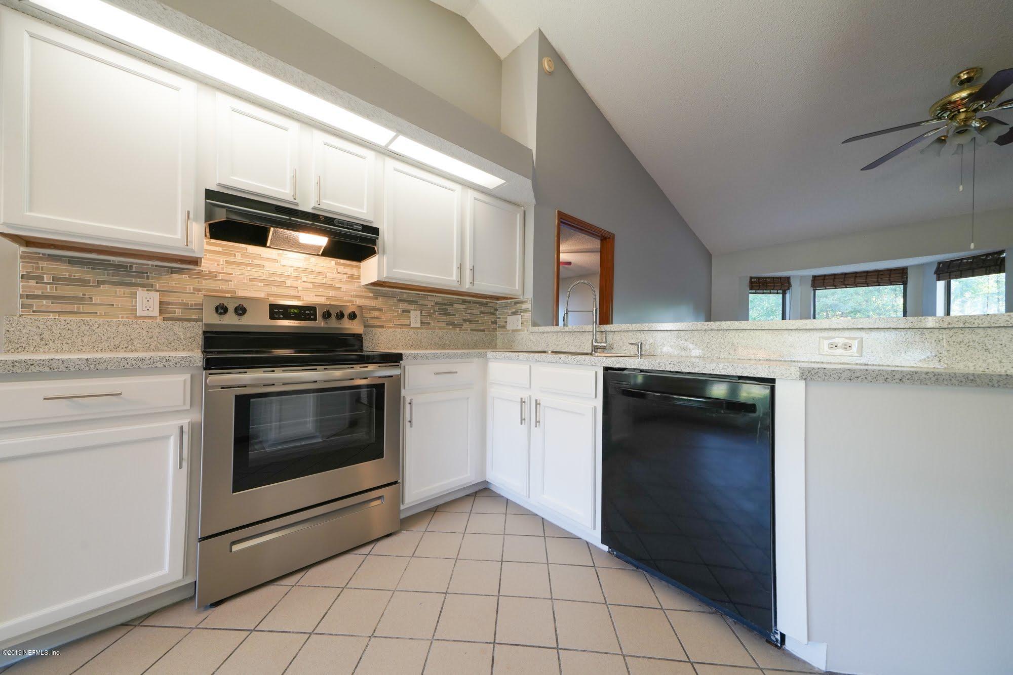 2148 Rothbury Drive Jacksonville, FL 32221 - Photo 10 of 36 a kitchen with a stove and a microwave