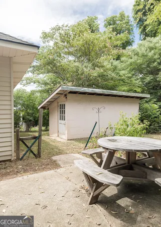a view of backyard with wooden deck and seating space