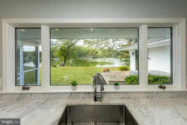 a kitchen with a stove and a white wooden cabinets