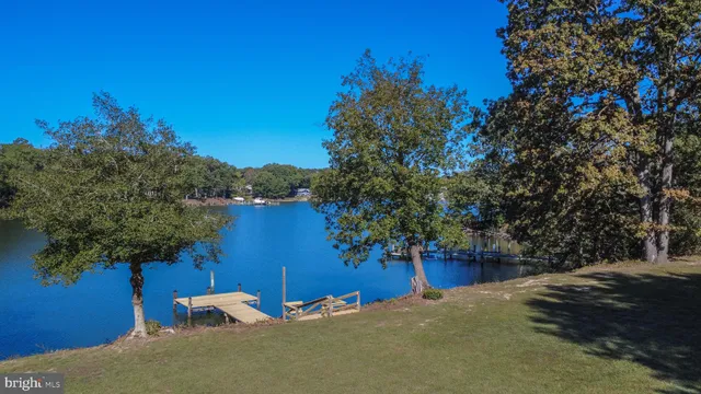 a front view of a house with yard and green space