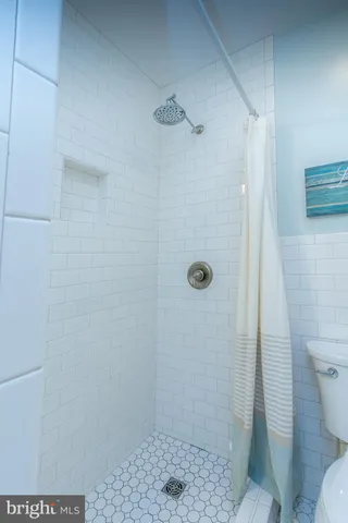 a front view of a house with a garden and trees