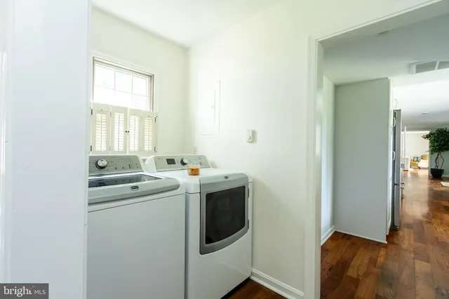 a view of a house with a yard and large trees