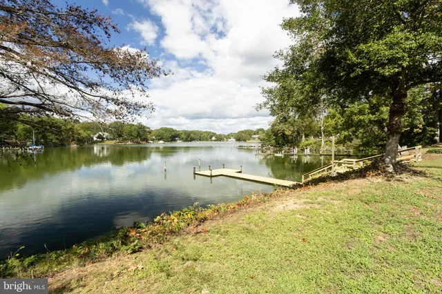 a front view of a house with a yard table and chairs