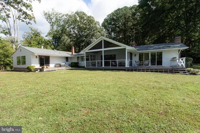 a view of a room with wooden floor and floor to ceiling windows