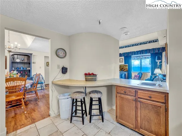 a view of a dining room with furniture wooden floor and a chandelier