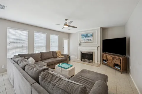 a living room with furniture a fireplace and a flat screen tv