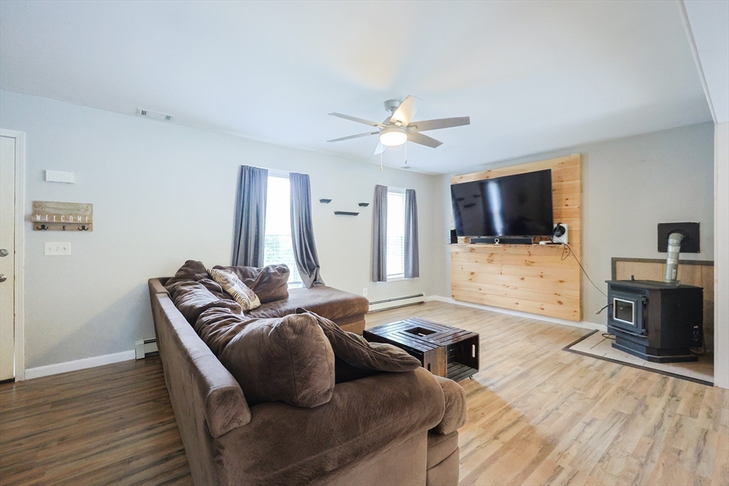 48 Wareham Street Carver, MA 02330 - Photo 16 of 42 a living room with furniture flat screen tv and a fireplace