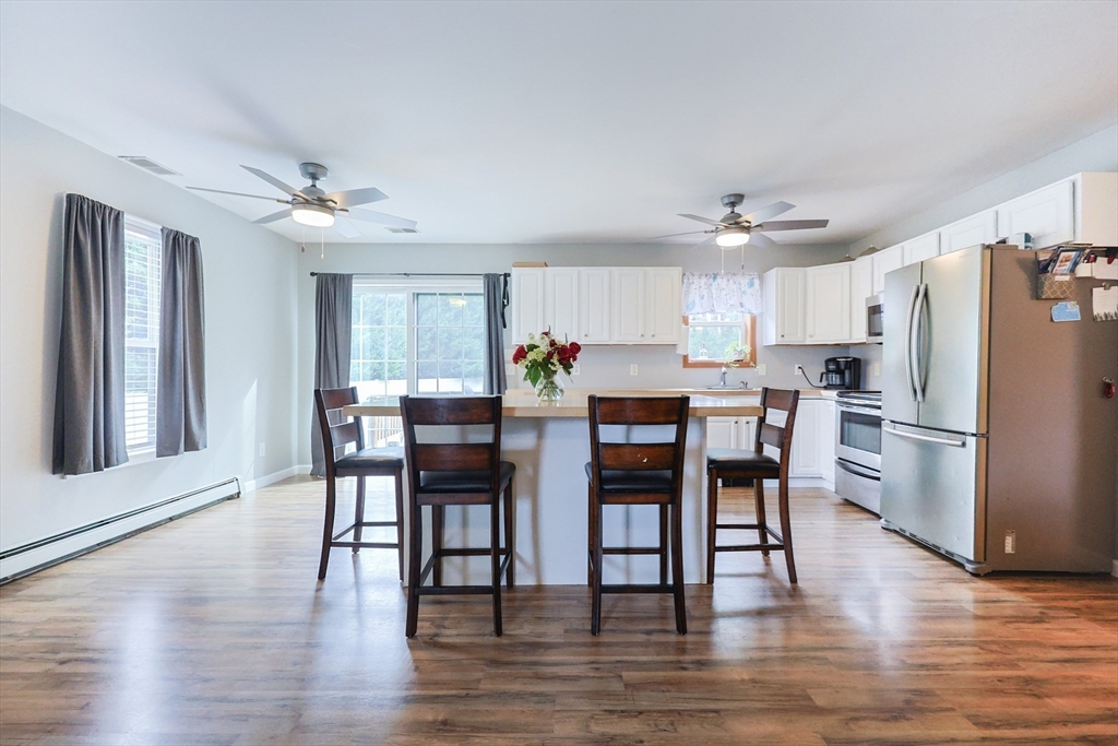48 Wareham Street Carver, MA 02330 - Photo 18 of 42 a view of a dining room with furniture and wooden floor