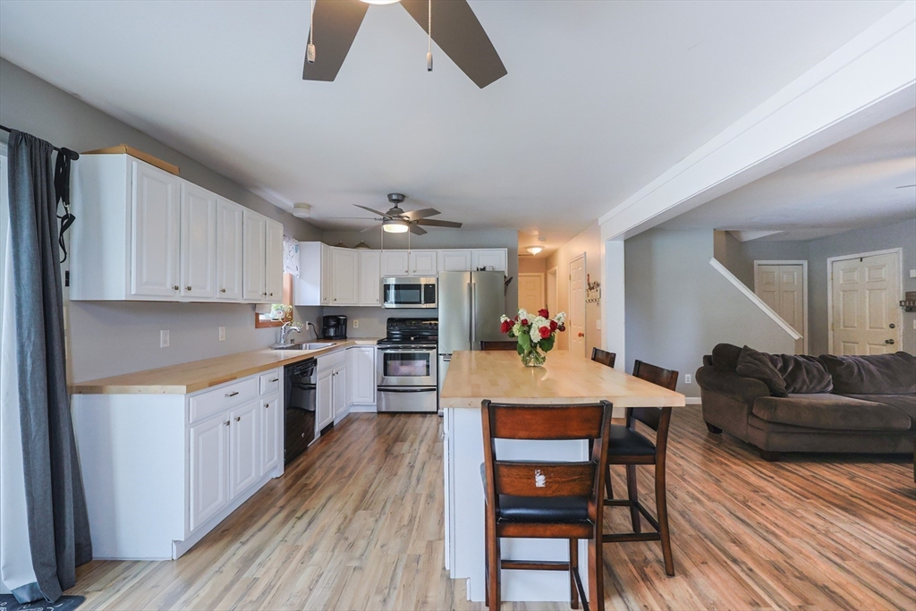 48 Wareham Street Carver, MA 02330 - Photo 20 of 42 a large kitchen with cabinets wooden floor and stainless steel appliances