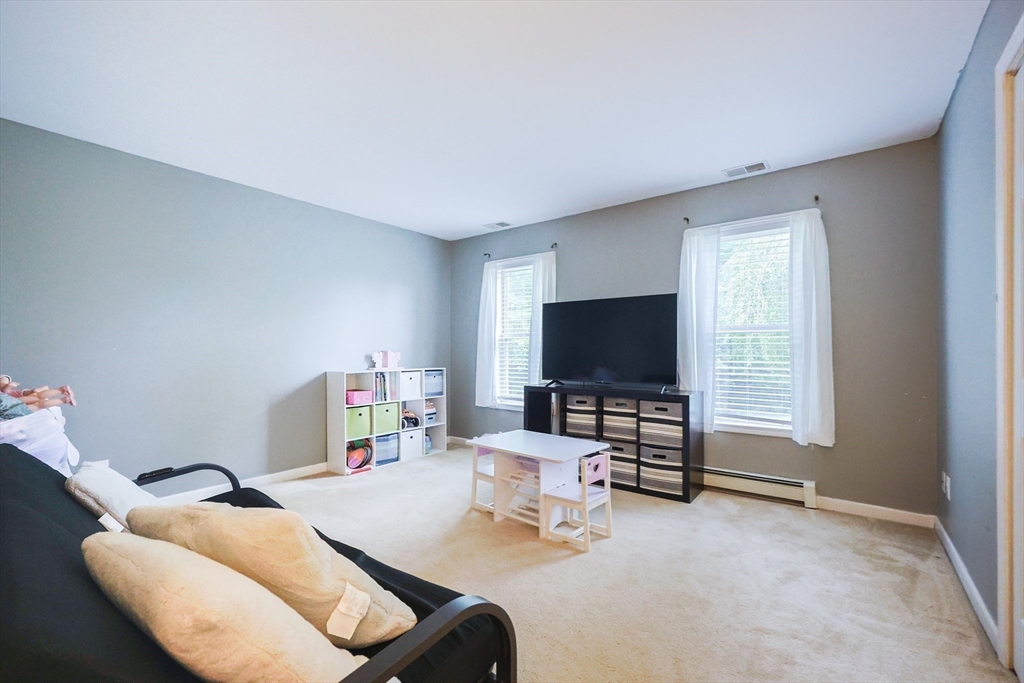 48 Wareham Street Carver, MA 02330 - Photo 24 of 42 a living room with furniture and a flat screen tv