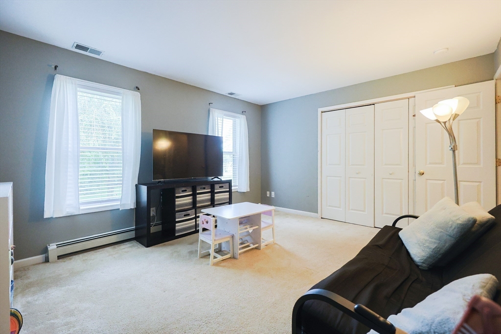48 Wareham Street Carver, MA 02330 - Photo 25 of 42 a living room with furniture and a flat screen tv