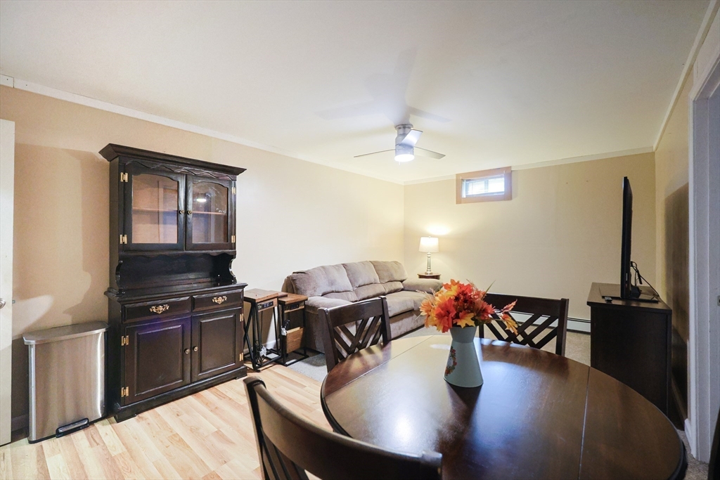 48 Wareham Street Carver, MA 02330 - Photo 36 of 42 a dining room with wooden floor a glass table and chairs