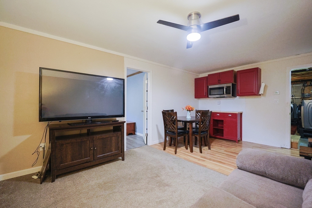48 Wareham Street Carver, MA 02330 - Photo 38 of 42 a living room with furniture and a flat screen tv