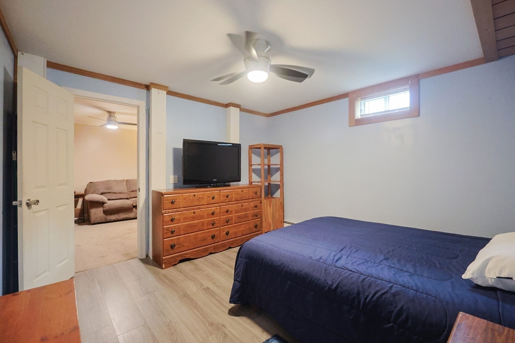 48 Wareham Street Carver, MA 02330 - Photo 39 of 42 a bedroom with a bed and a flat screen tv