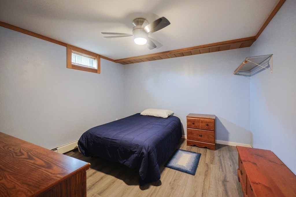 48 Wareham Street Carver, MA 02330 - Photo 40 of 42 a bed room with a bed and a chandelier
