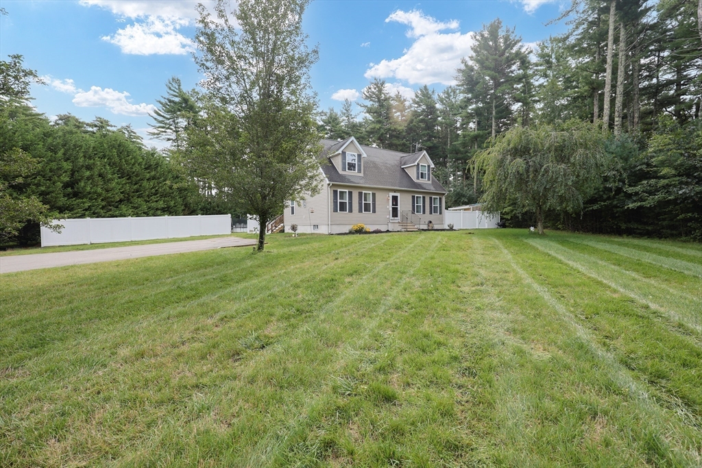48 Wareham Street Carver, MA 02330 - Photo 4 of 42 a view of a house with a big yard and large trees