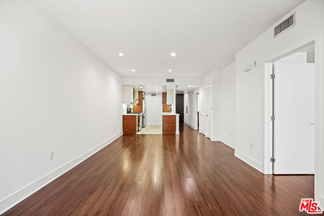 220 East Broadway, Unit 202 Glendale, CA 91205 - Photo 5 of 13 a view of an empty room with wooden floor